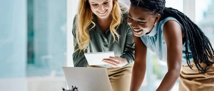 young-co-workers-looking-laptop-smiling
